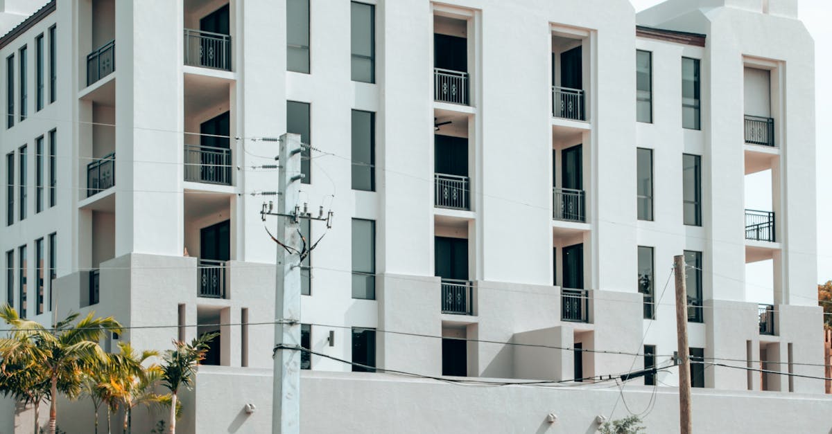 Elegant modern apartment building exterior in Coral Gables, Florida, under a clear blue sky.