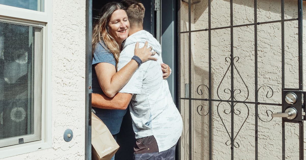 A happy moment capturing a man and woman embracing at a home's entrance, symbolizing togetherness.